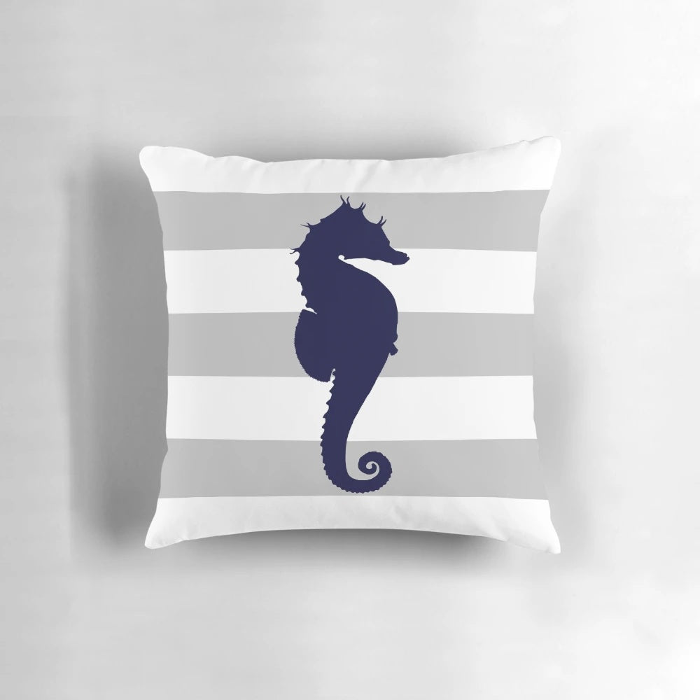 Navy blue and silver gray striped pillow with a seahorse design