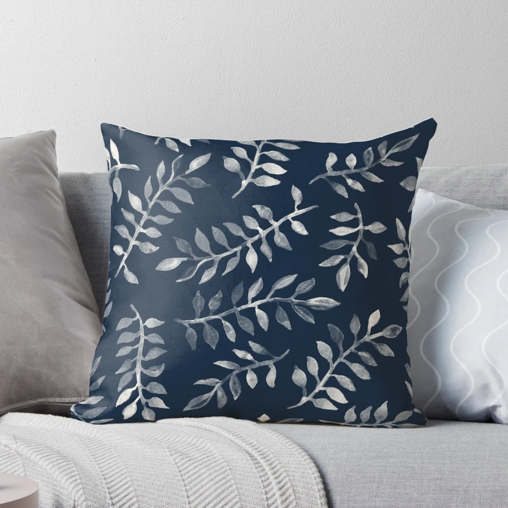 Navy blue and white hand-painted throw pillow with a botanical leaf pattern