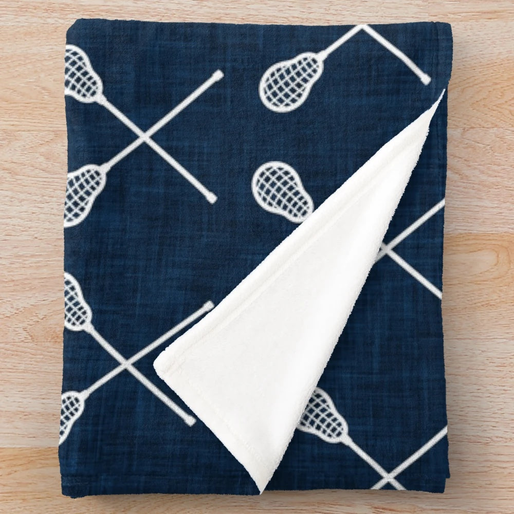Navy plush blanket with lacrosse crossed sticks design