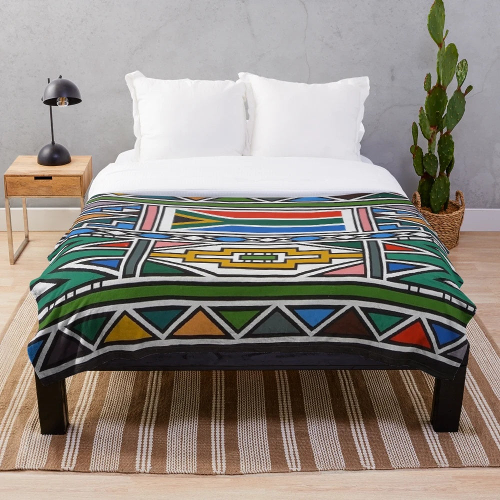 Ndebele-inspired plush blanket with vibrant tribal design