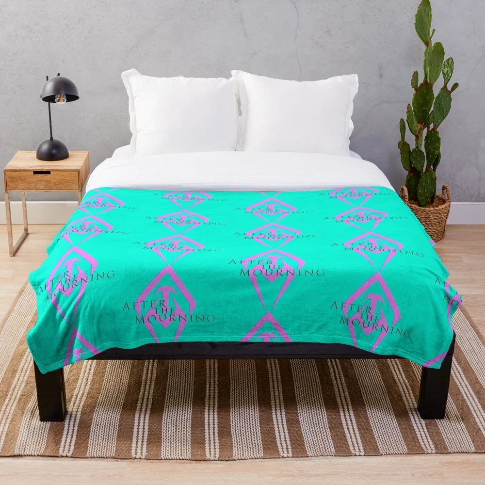 Neon pink and aqua plush blanket featuring the After the Mourning band logo