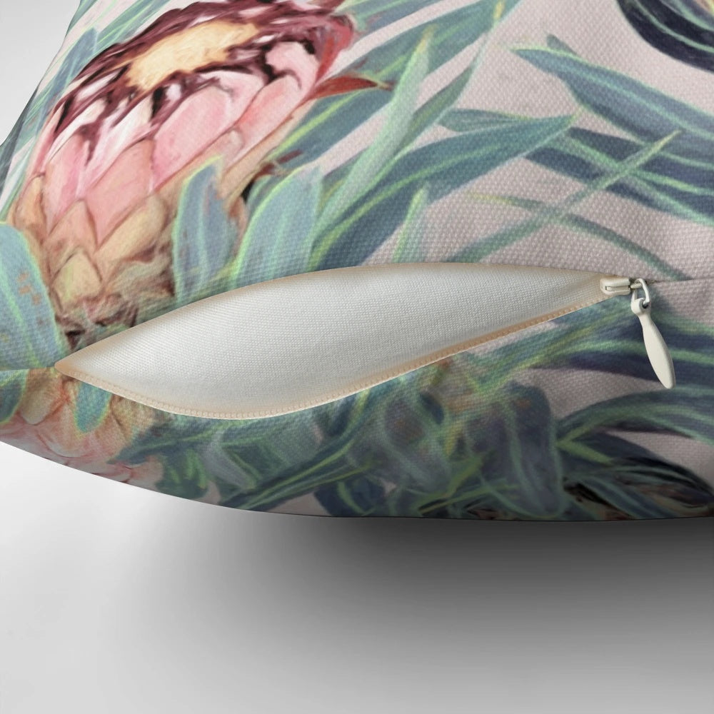 Vibrant painted protea neriifolia flower pattern on a soft, dusty pink decorative pillow