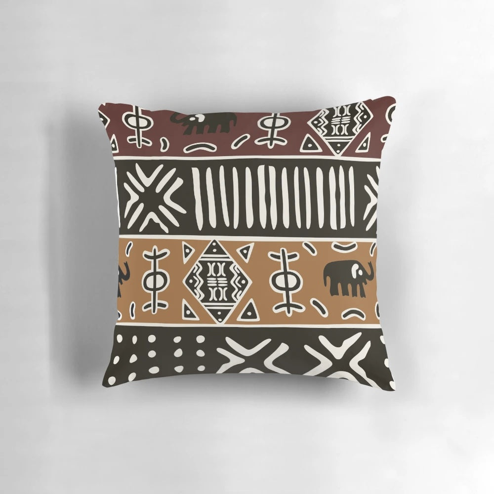 Neutral-toned pillow with a tribal African-inspired elephant pattern