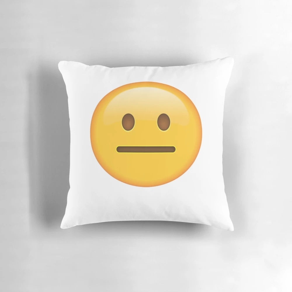 Neutral face emoji printed on a soft, cotton pillow for home or office decor.