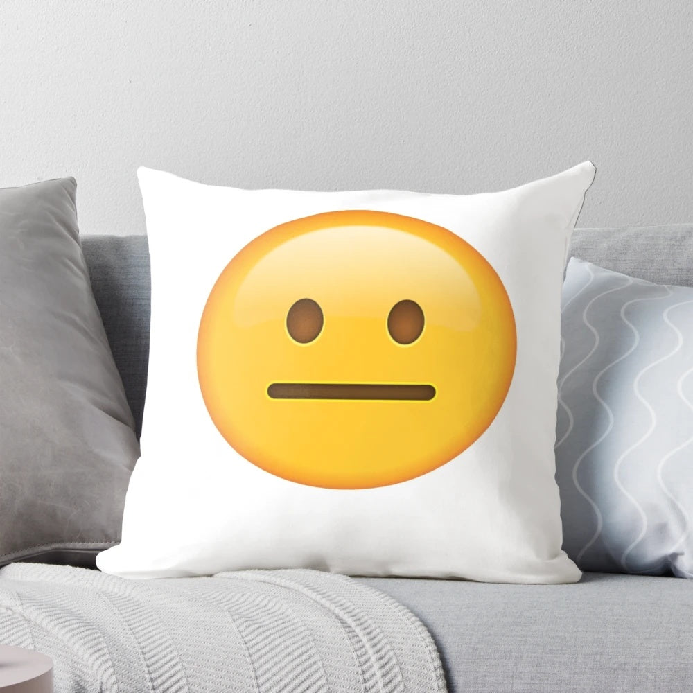 Neutral face emoji printed on a soft, cotton pillow for home or office decor.