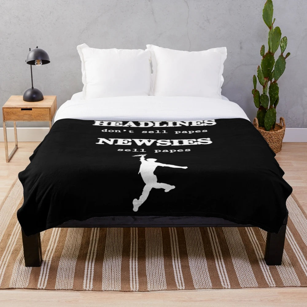 Newsies-inspired plush blanket with musical and theater-themed graphics