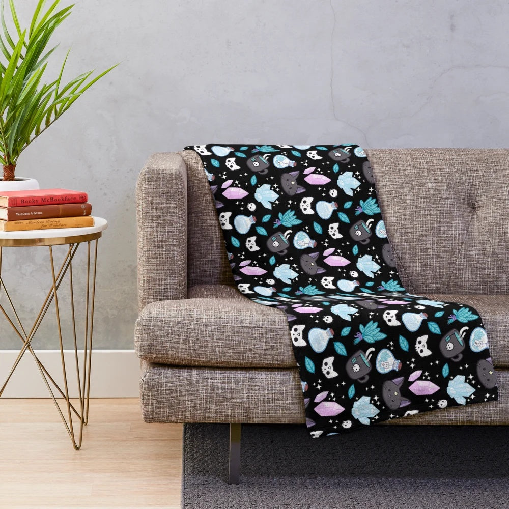 Nikury black plush blanket featuring a witch and cat design