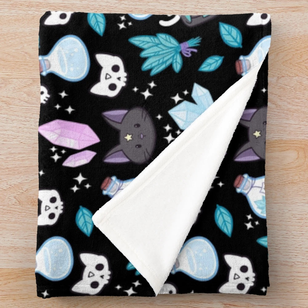 Nikury black plush blanket featuring a witch and cat design