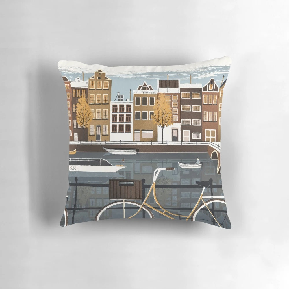 Vintage-inspired Amsterdam pillow featuring a scenic canal, bicycles, and historic architecture