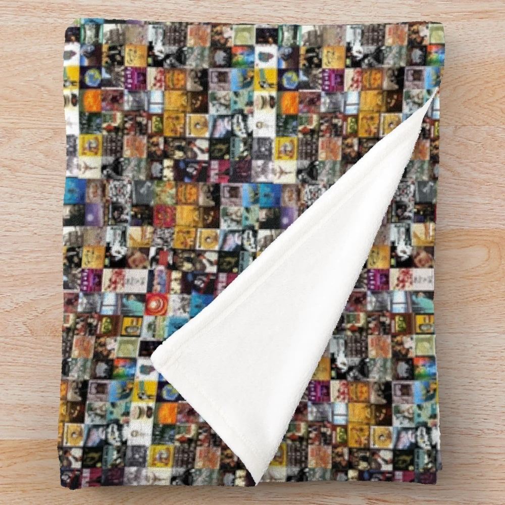 Vintage plush blanket featuring a montage of retro music covers