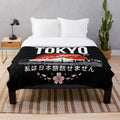 Plush blanket with "I Don't Speak Japanese" design, featuring Japanese elements like cherry blossoms and Tokyo