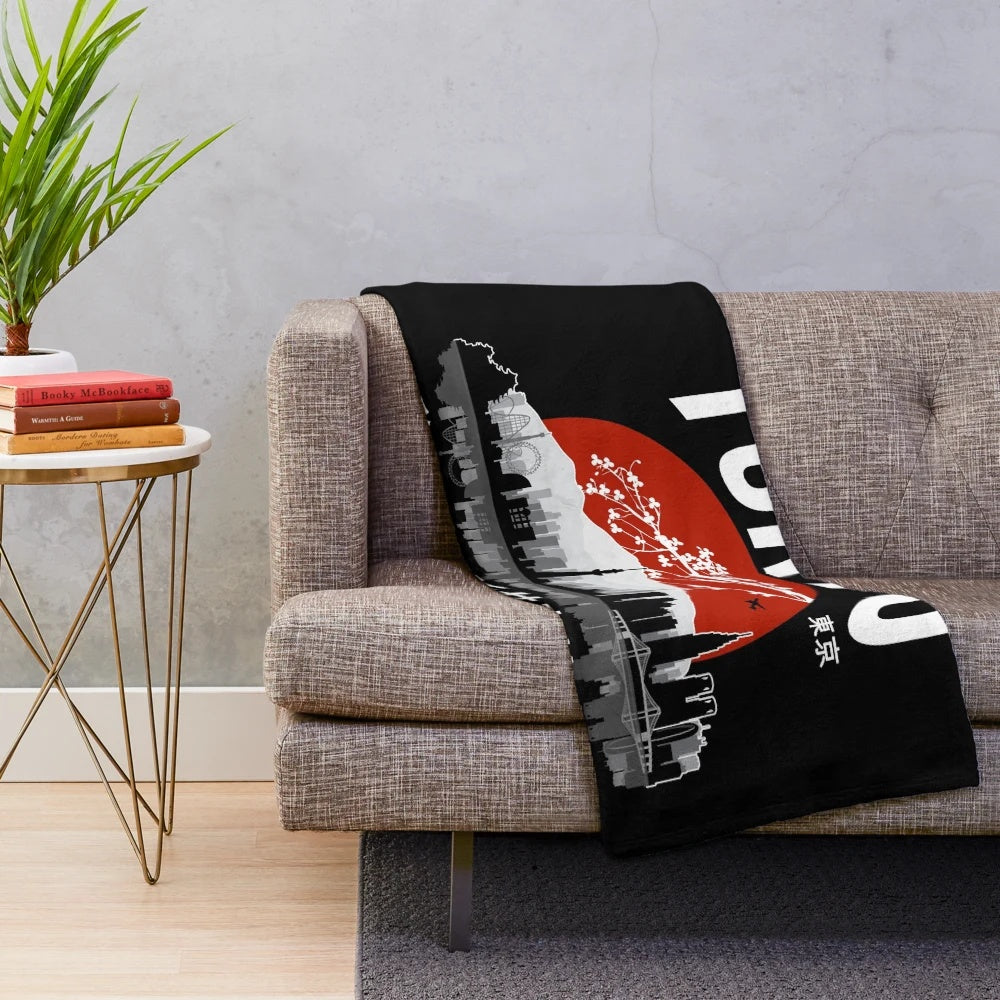 Plush blanket with "I Don't Speak Japanese" design, featuring Japanese elements like cherry blossoms and Tokyo