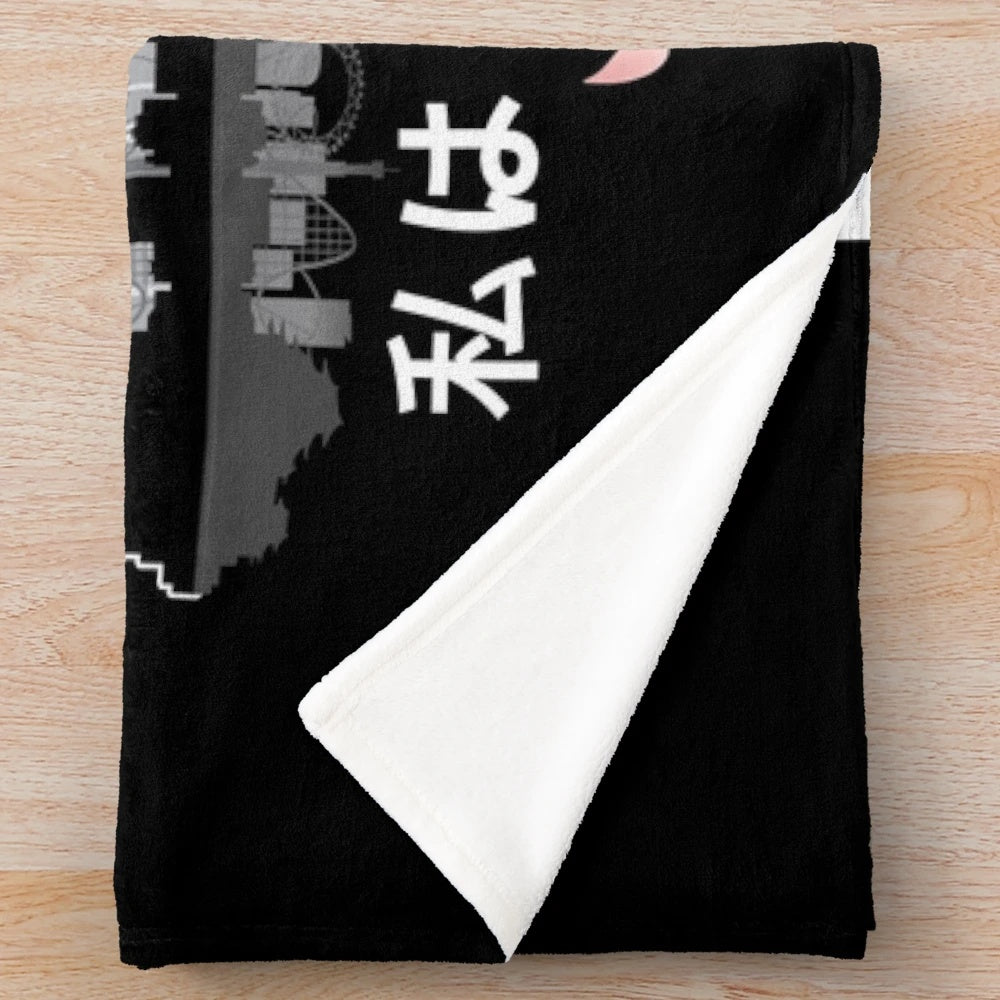 Plush blanket with "I Don't Speak Japanese" design, featuring Japanese elements like cherry blossoms and Tokyo