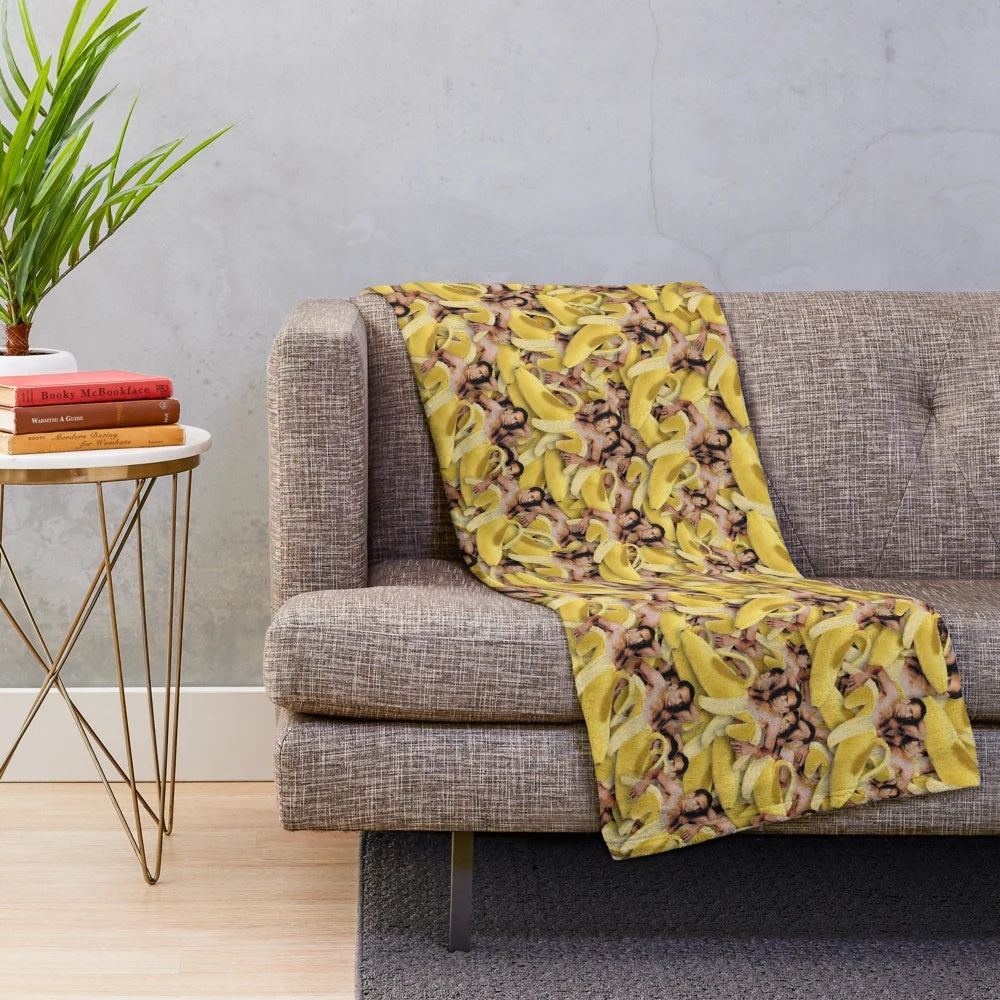 Cozy plush blanket featuring a collage of Nicolas Cage's iconic face in a banana pattern.