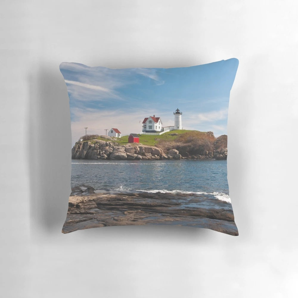 Nubble Light Coastal Pillow showcasing a picturesque Maine lighthouse by the Atlantic Ocean