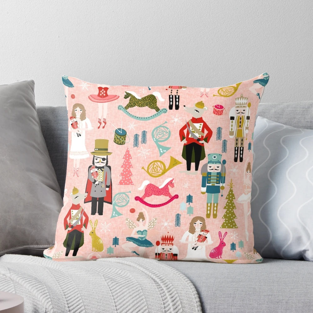 Blush-colored Nutcracker ballet-themed pillow with dance and classical music motifs