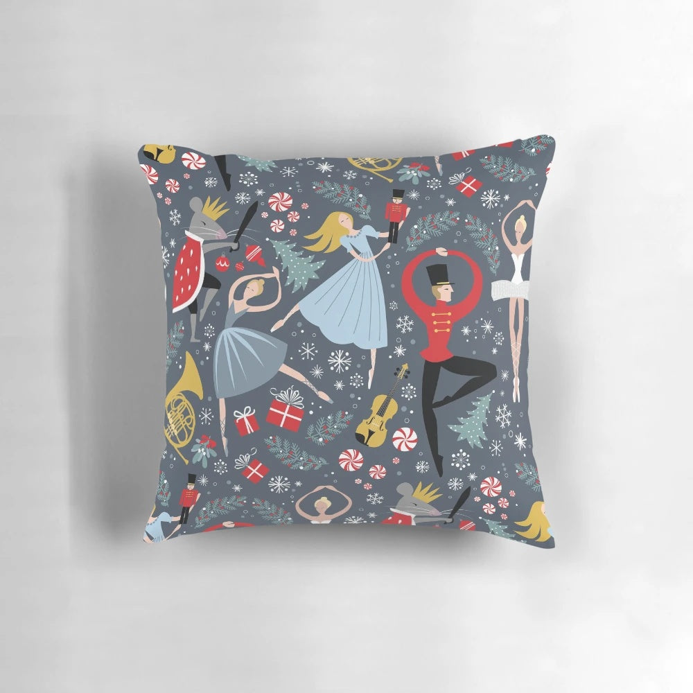 A Pillow featuring a Nutcracker Ballet design by Robin Pickens, showcasing dancers and the iconic Clara character.