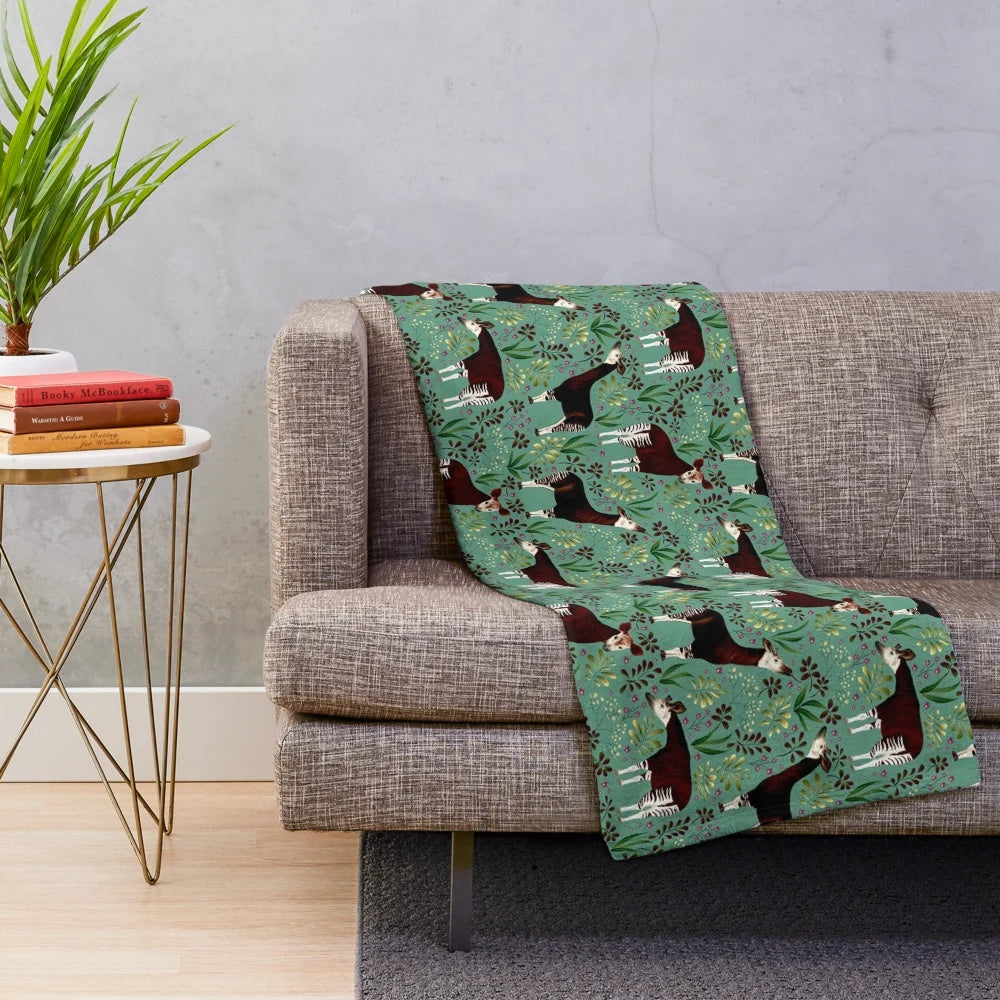 Okapi-inspired plush blanket featuring a vibrant forest giraffe design