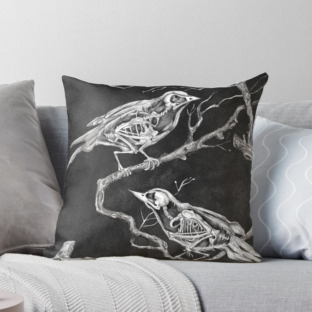 A black and white pillow design featuring a skeleton and birds, conveying a sense of melancholy and forgetfulness.