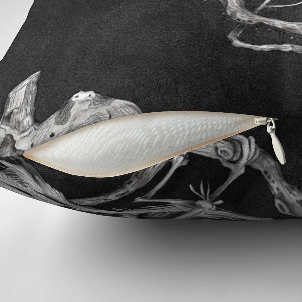 A black and white pillow design featuring a skeleton and birds, conveying a sense of melancholy and forgetfulness.