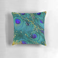 A decorative throw pillow featuring a dreamy design of peacock feathers in shades of teal and purple with a glimmering gold accent.