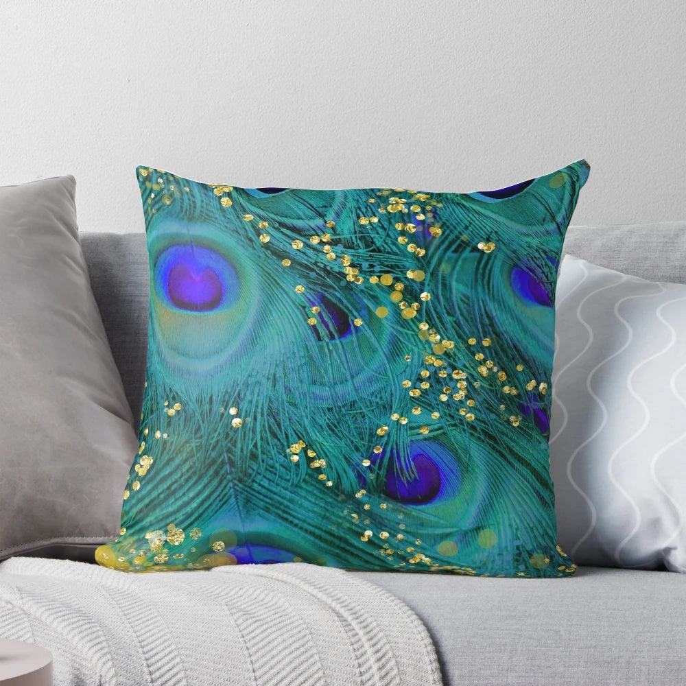 A decorative throw pillow featuring a dreamy design of peacock feathers in shades of teal and purple with a glimmering gold accent.