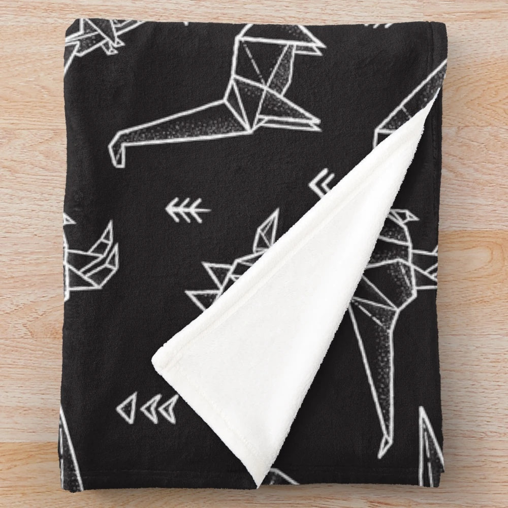 Origami dinosaur plush blanket with geometric pattern