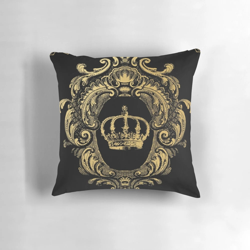Ornate black and gold pillow with a regal, baroque-inspired crown design