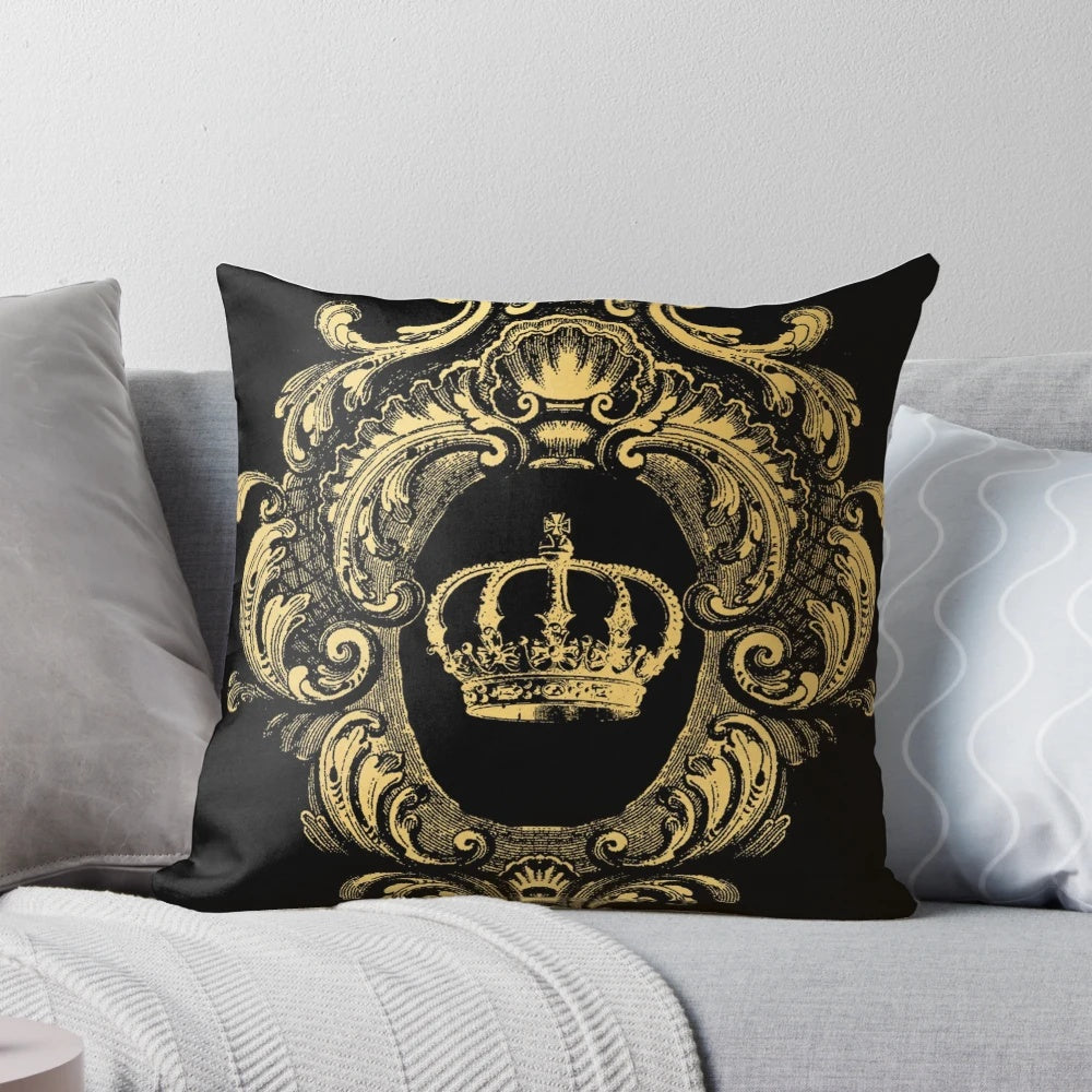 Ornate black and gold pillow with a regal, baroque-inspired crown design