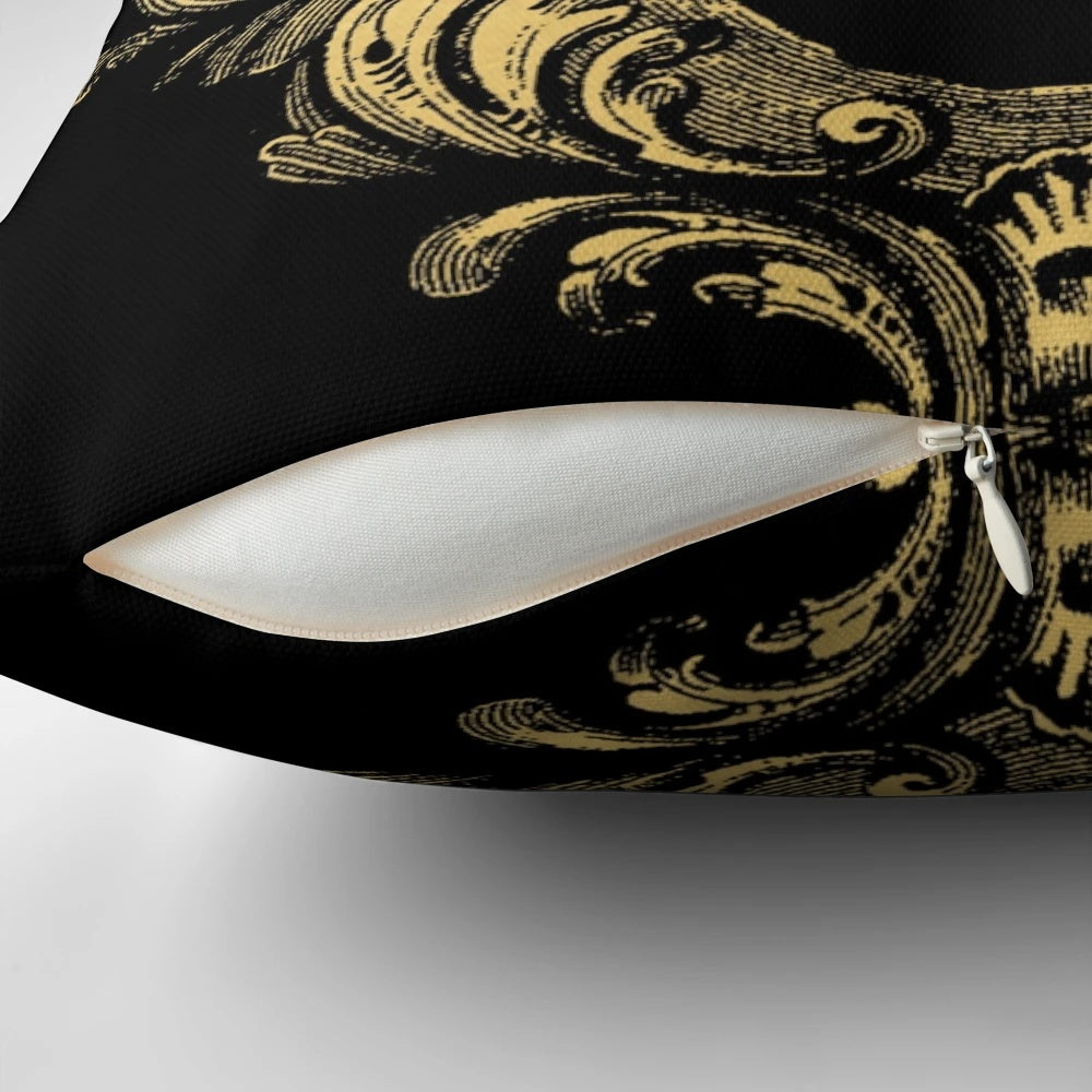 Ornate black and gold pillow with a regal, baroque-inspired crown design
