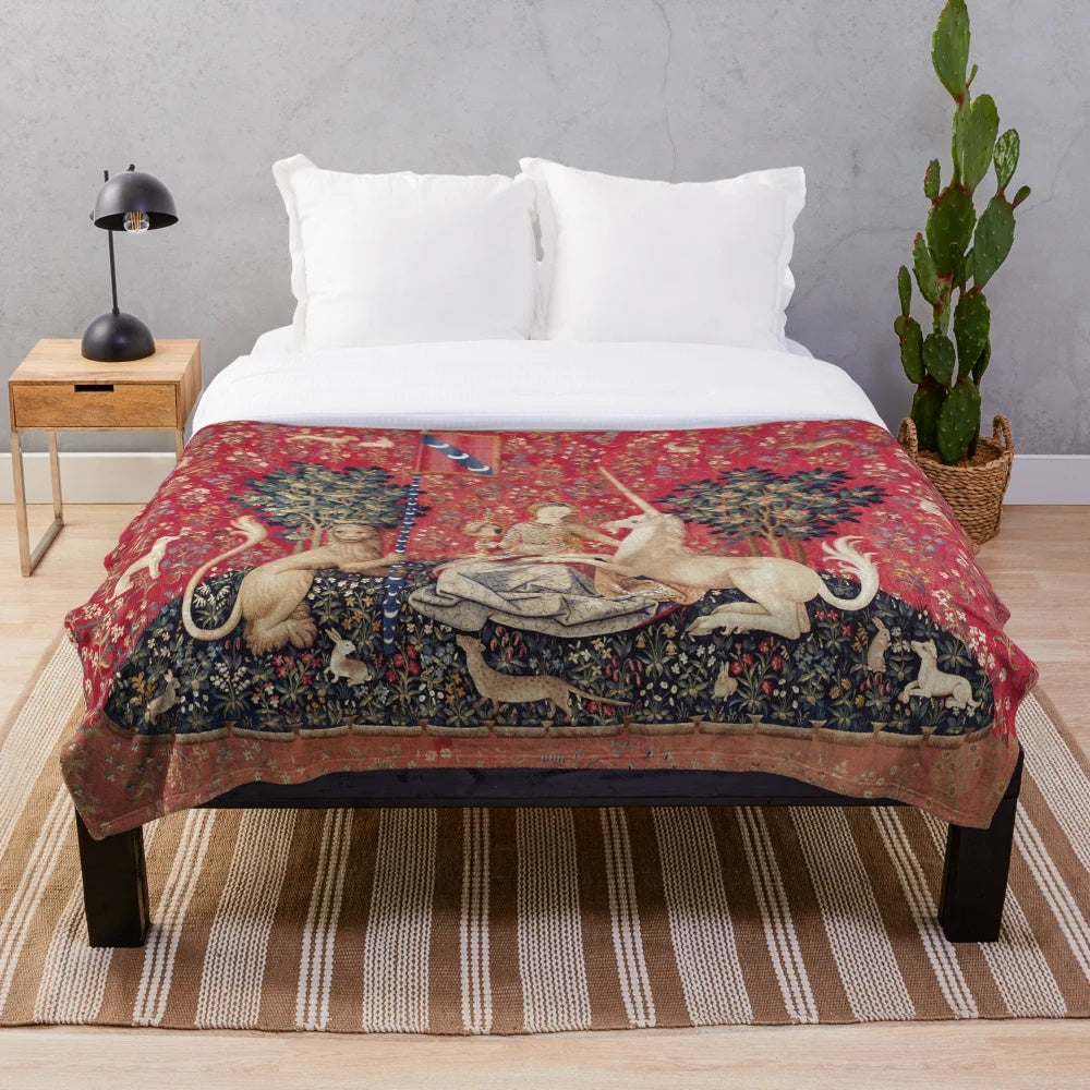 Plush blanket featuring a medieval-inspired tapestry design with a lady and unicorn, representing the five senses.