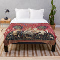 Plush blanket featuring a medieval-inspired tapestry design with a lady and unicorn, representing the five senses.