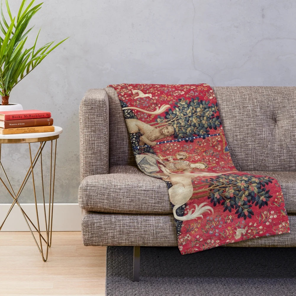 Plush blanket featuring a medieval-inspired tapestry design with a lady and unicorn, representing the five senses.
