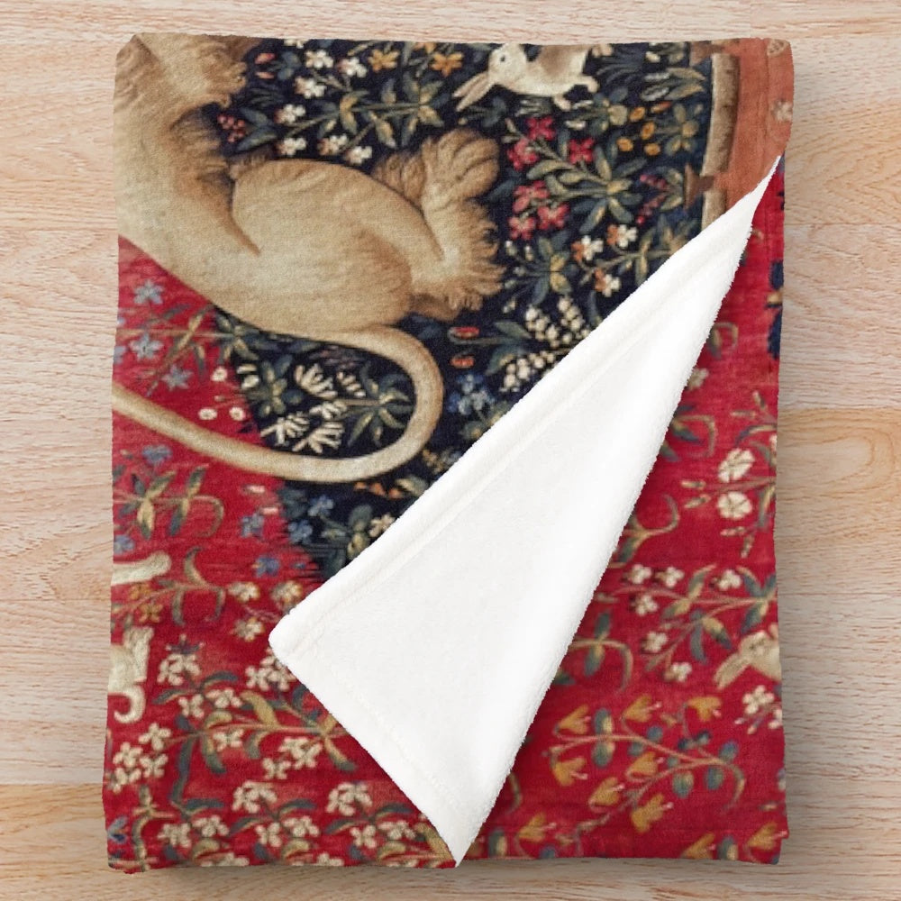 Plush blanket featuring a medieval-inspired tapestry design with a lady and unicorn, representing the five senses.