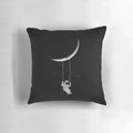 A black and white, surrealist-inspired pillow with a crescent moon design, perfect for creating a whimsical, out-of-this-world ambiance.