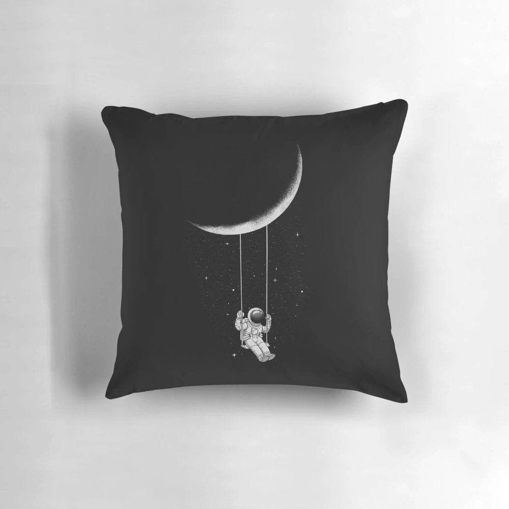 A black and white, surrealist-inspired pillow with a crescent moon design, perfect for creating a whimsical, out-of-this-world ambiance.