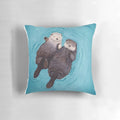Soft, plush pillow featuring a pair of adorable sea otters holding hands, perfect for romantic home decor.