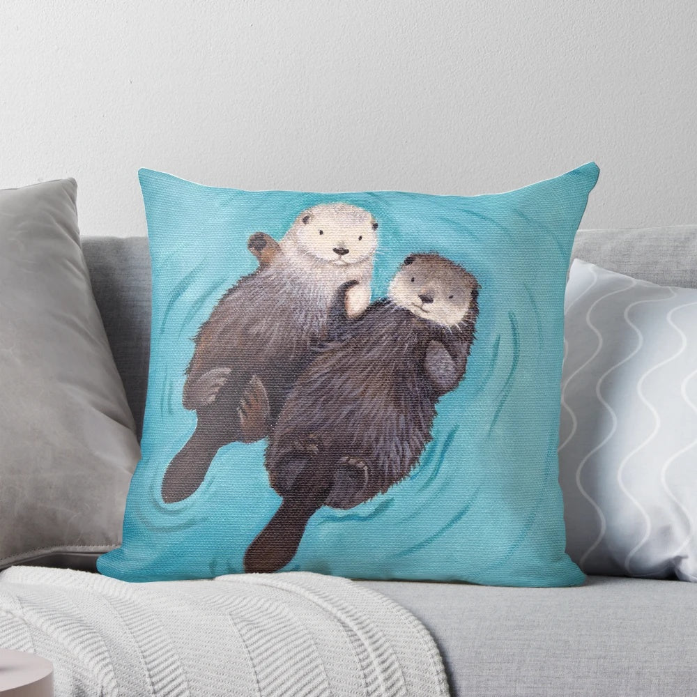 Soft, plush pillow featuring a pair of adorable sea otters holding hands, perfect for romantic home decor.