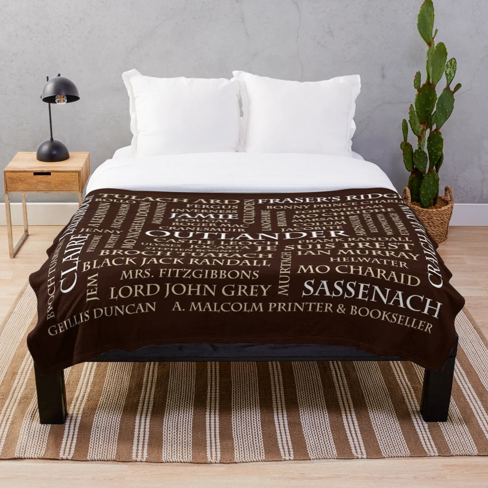 Outlander-inspired plush blanket with word cloud design featuring show elements