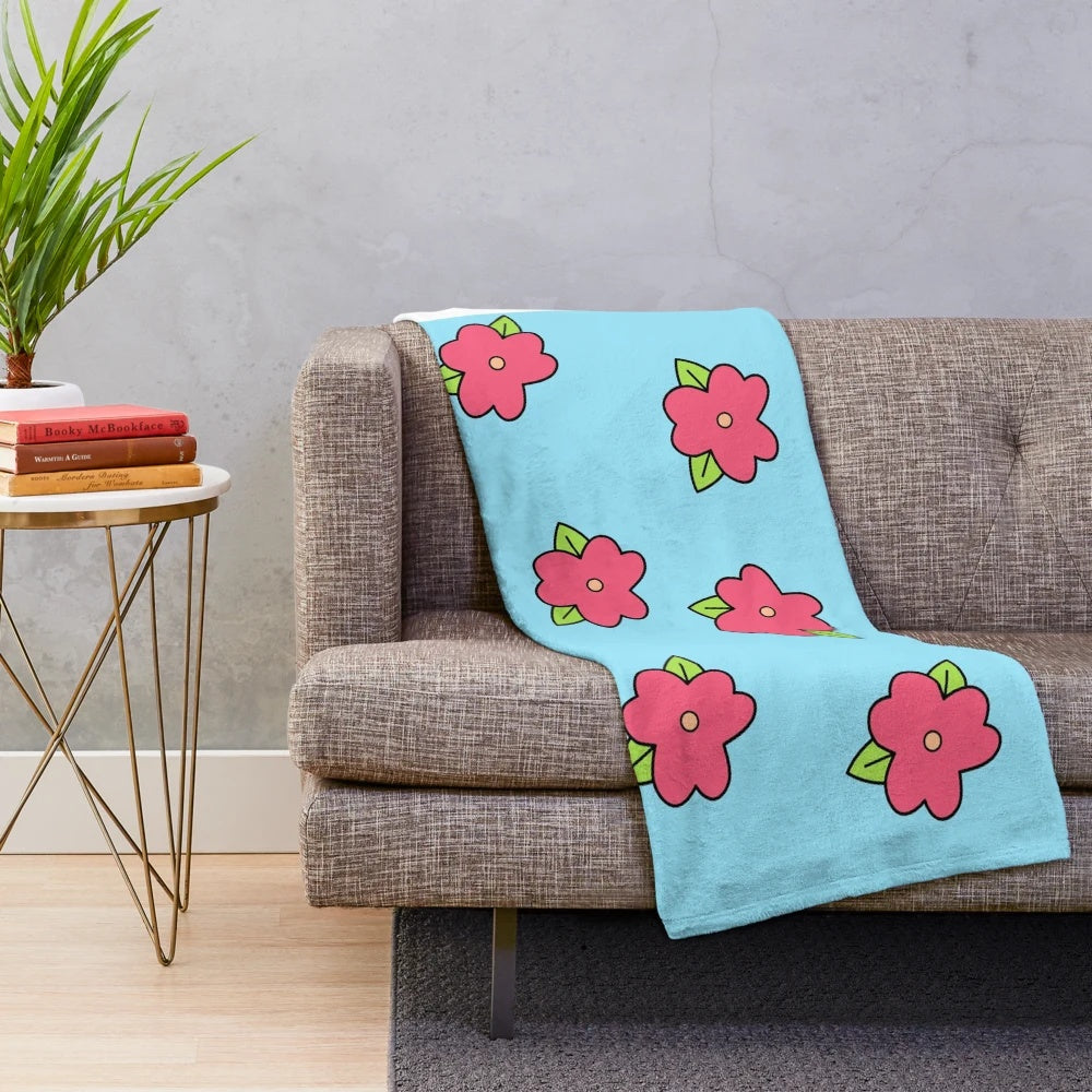 Plush blanket featuring a colorful Hawaiian-inspired floral print, inspired by Homer Simpson's iconic muumuu