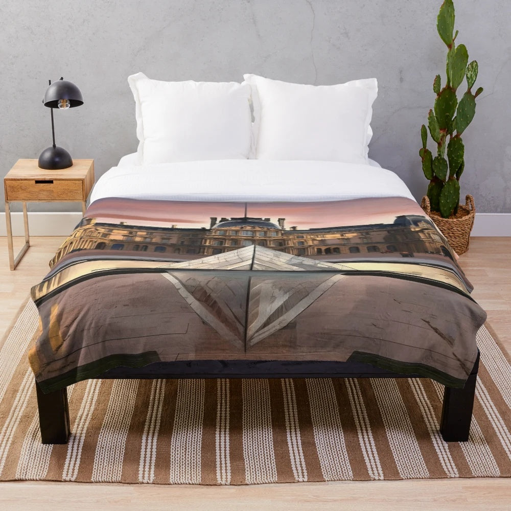 Plush blanket featuring an illustration of the iconic Louvre Museum in Paris
