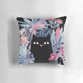 Pastel black velvet pillow with a tropical floral design featuring a cute black cat