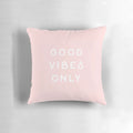 Pastel pink and blush colored pillow with small text, evoking a minimalist, California desert aesthetic.