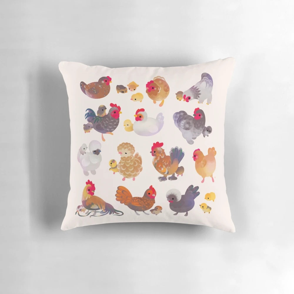 A pastel-colored pillow featuring an illustration of a chicken and chick
