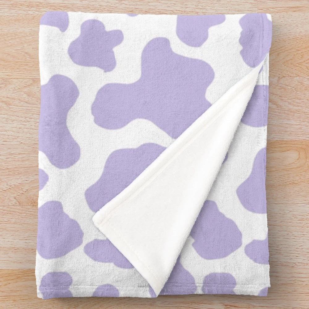 Soft and cozy pastel cow print plush blanket for aesthetic-inspired decor