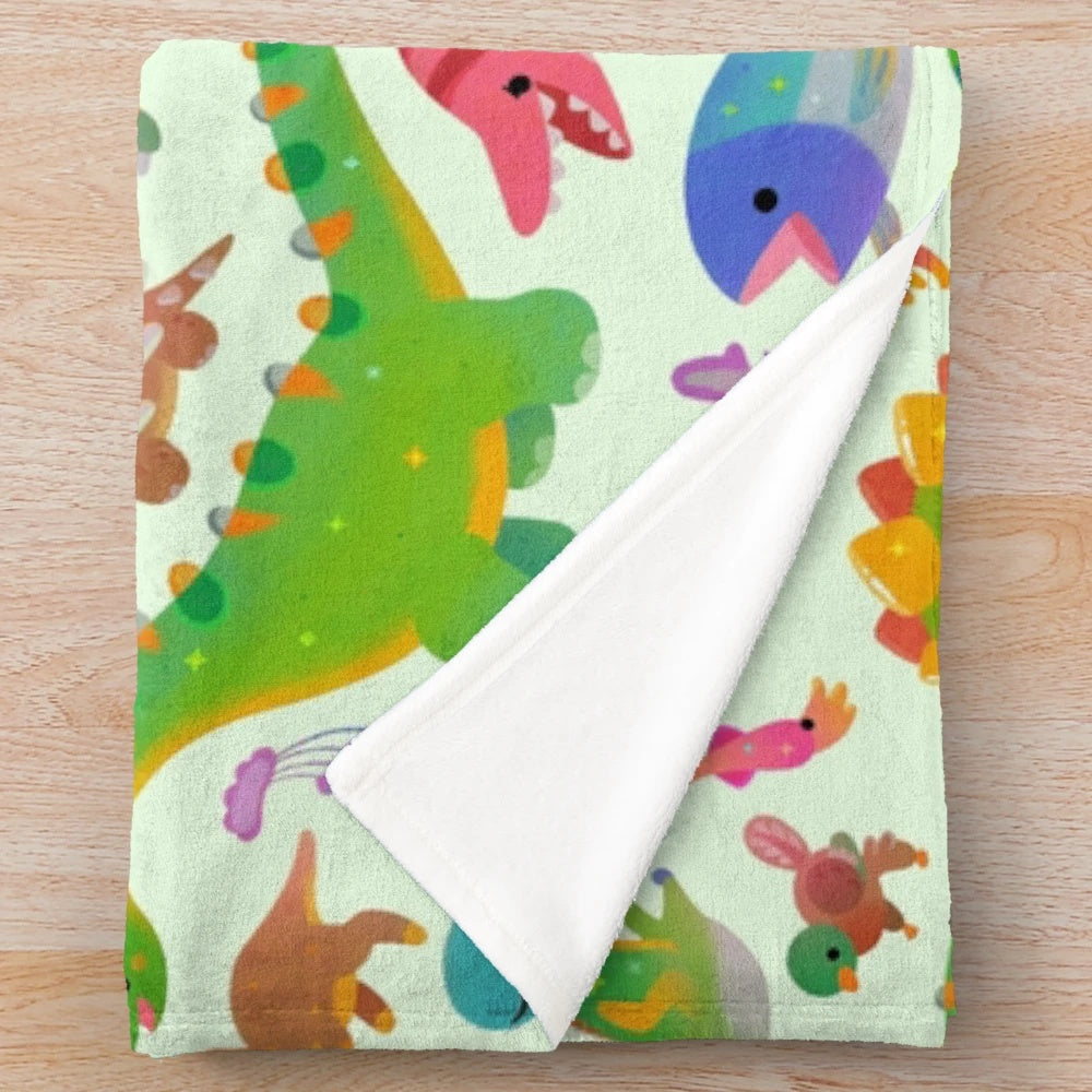 Pastel colored plush blanket with dinosaur design
