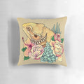 Pastel-colored pillow featuring a bearded dragon design with floral and botanical elements