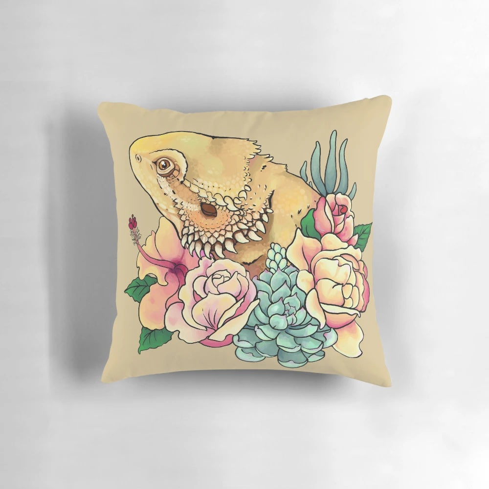 Pastel-colored pillow featuring a bearded dragon design with floral and botanical elements