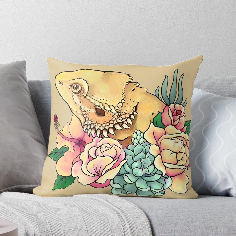 Pastel-colored pillow featuring a bearded dragon design with floral and botanical elements