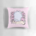 A pastel pink pillow featuring a beautiful floral design, with a touch of mystical elements like a crystal ball, perfect for creating a cozy and whimsical atmosphere.